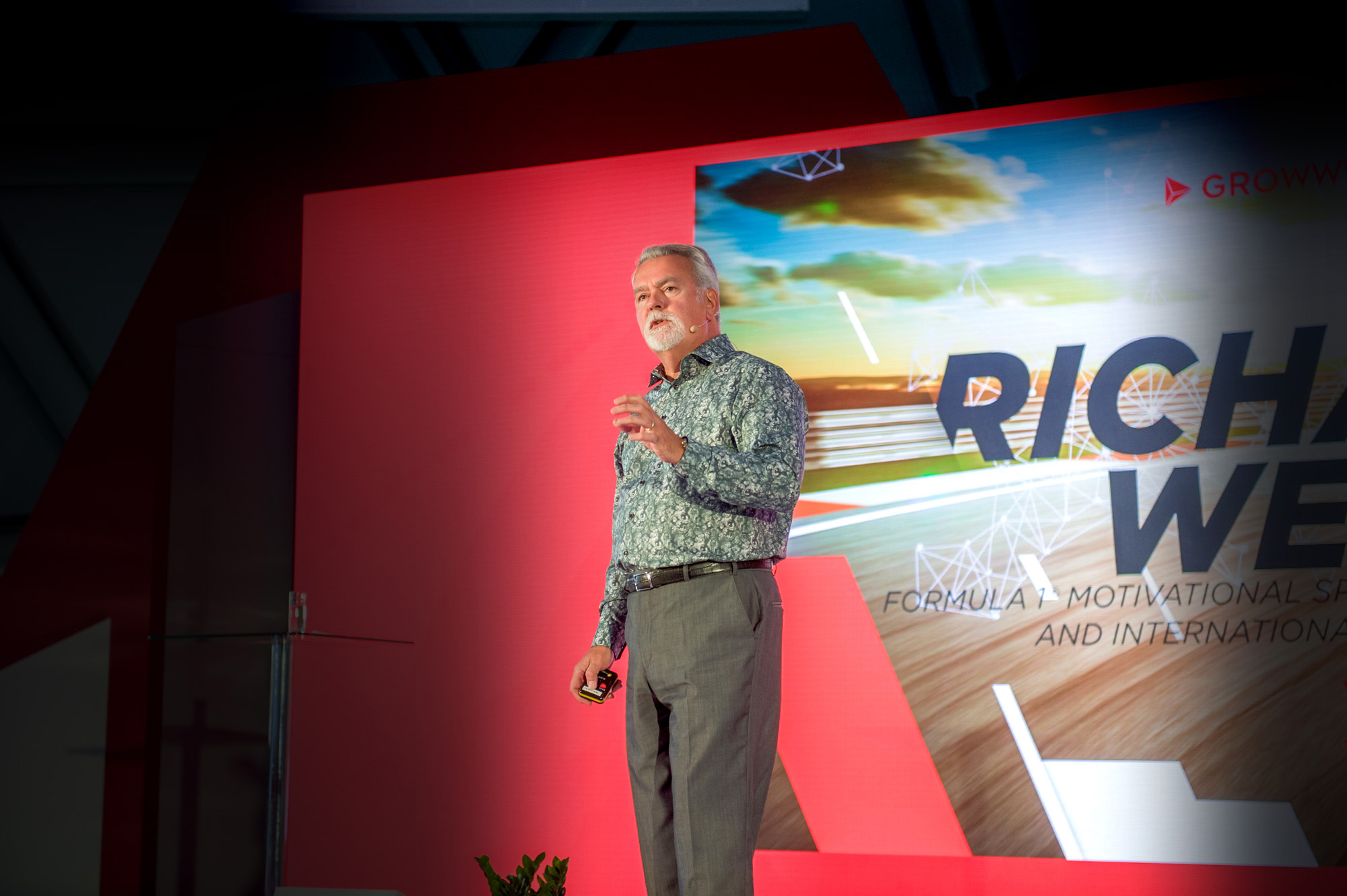 Richard West Keynote Speaker, Event Host & Facilitator, F1 backdrop Photo